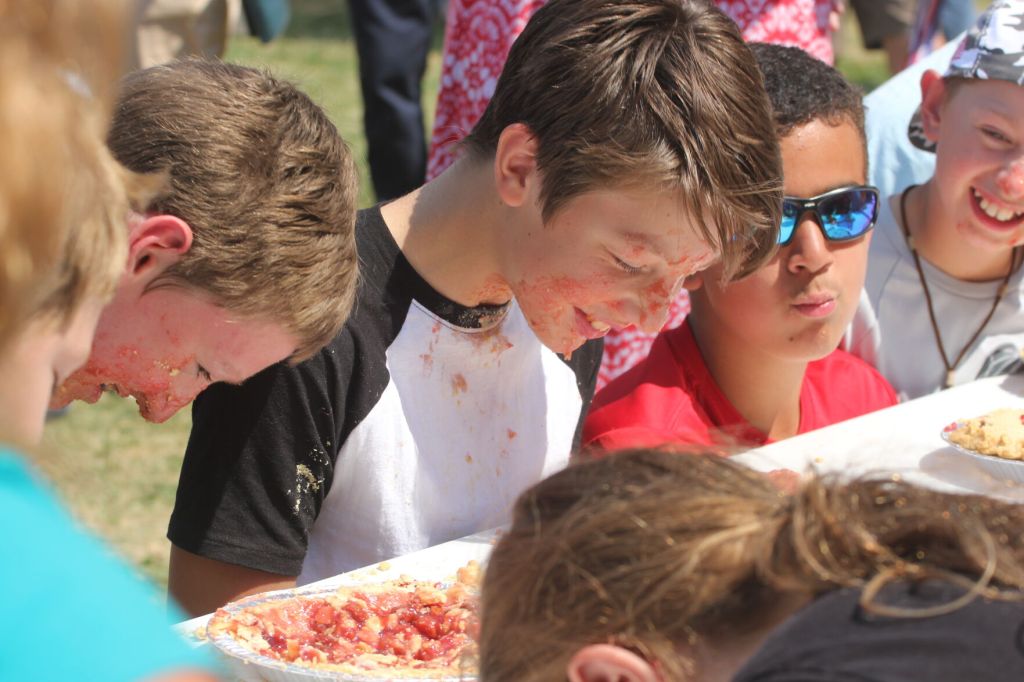 No manners — and no hands — allowed at the Cove Cherry Fair’s messy pie eating contest. The 25th annual festival is Aug. 16, 2025. (The Observer, File)