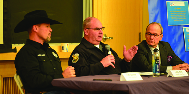 La Grande Police Chief Gary Bell, middle, addresses community members along with Union County Sheriff Cody Bowen, left, and Union County Circuit Court Judge Thomas Powers, on Oct. 23, 2025, at the Union County unit of the League of Women Voters' inaugural town hall. Bell, Bowen and Powers discussed how the 2024 change to Oregon’s drug law affected Union County. (Isabella Crowley/The Observer)